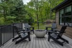 Second floor balcony with Adirondack chairs and gas firepit